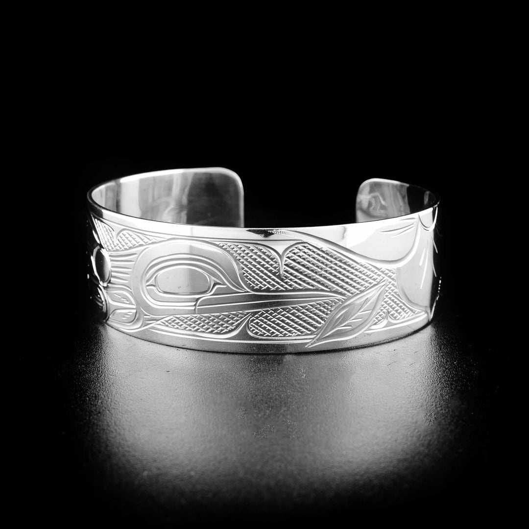 Sterling silver hummingbird bracelet hand-carved by Kwakwaka'wakw artist Victoria Harper. Bracelet is 6.19" long with 0.88" gap and is 0.75" wide.