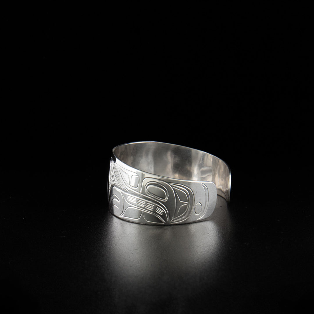 Sterling silver hummingbird bracelet hand-carved by Kwakwaka'wakw artist Don Lancaster. 6.19" long with 0.69" gap. 0.75" wide with tapered ends.