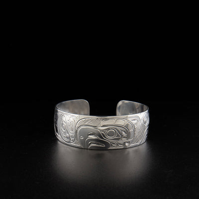 Sterling silver thunderbird and orca bracelet hand-carved by Kwakwaka'wakw artist Don Lancaster. 6.19" long with 0.75" gap. 0.75" wide.
