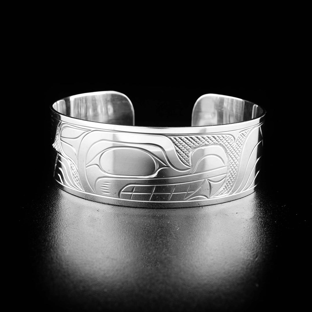 Sterling silver wolf bracelet hand-carved by Kwakwaka'wakw artist Victoria Harper. Bracelet is 6.19" long with 0.69" gap and is 0.75" wide.