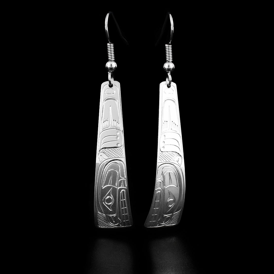 These bear earrings are triangle shaped and have the profile of a bear's head with a sneer on the bottom of each earring facing downwards. There is a paw and fur above.