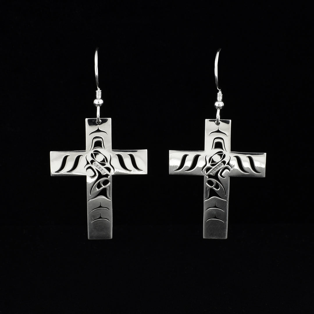 These sterling silver cross earrings have wide, cross shaped hangs with cutout designs depicting the Wolf on them.