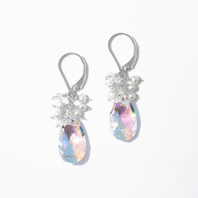 Dazzling lever back earrings handcrafted by artist Debra Nelson. Made of sterling silver, Aurora Borealis Swarovski Crystal and white seed pearls. Each earring measures 1.50" x 0.38" including hook.