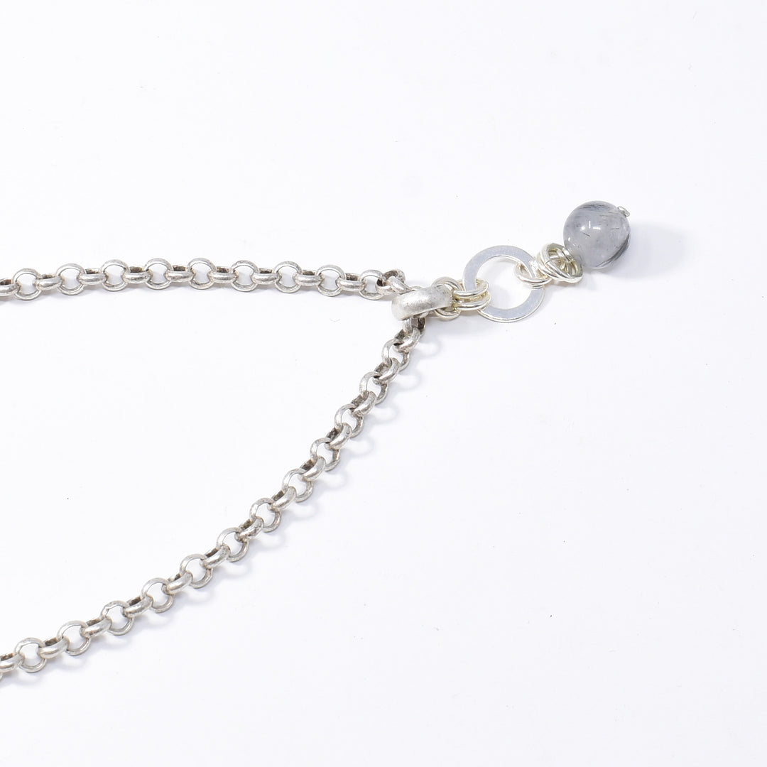 Unique Tourmalinated Quartz Pendant Necklace handcrafted by artist Karley Smith. Pendant made of tourmalinated quartz, sterling silver and antique silver. Antique silver rolo chain included. Pendant measures 1.20" x 0.40" including bail and chain is 20" long.