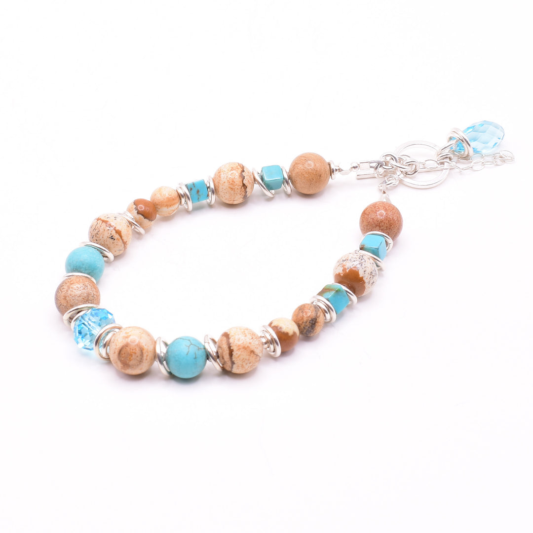 Turquoise Landscape Jasper Bracelet handcrafted by artist Karley Smith. Made of landscape jasper, Swarovski Crystal, turquoise and sterling silver. The bracelet closes with a toggle clasp and a safety chain adds an extra element of security. Bracelet is 7.50" long when clasped shut.