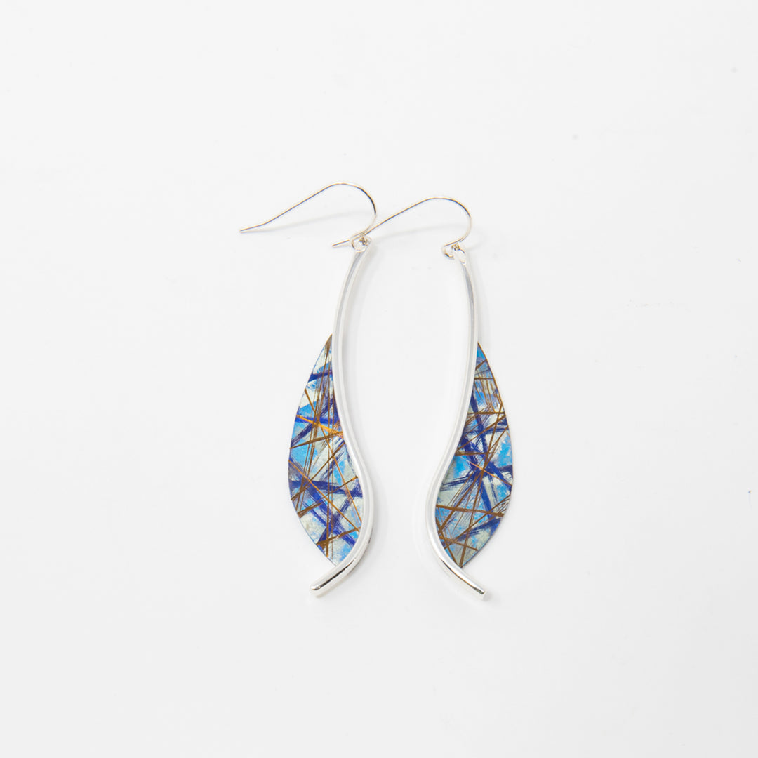 These titanium earrings are made from sterling silver and anodized titanium. There are curved, sterling silver wires dropping down with teardrop shaped titanium hangs at the bottom. There is an array of colors and designs on the hangs achieved by anodizing the titanium.