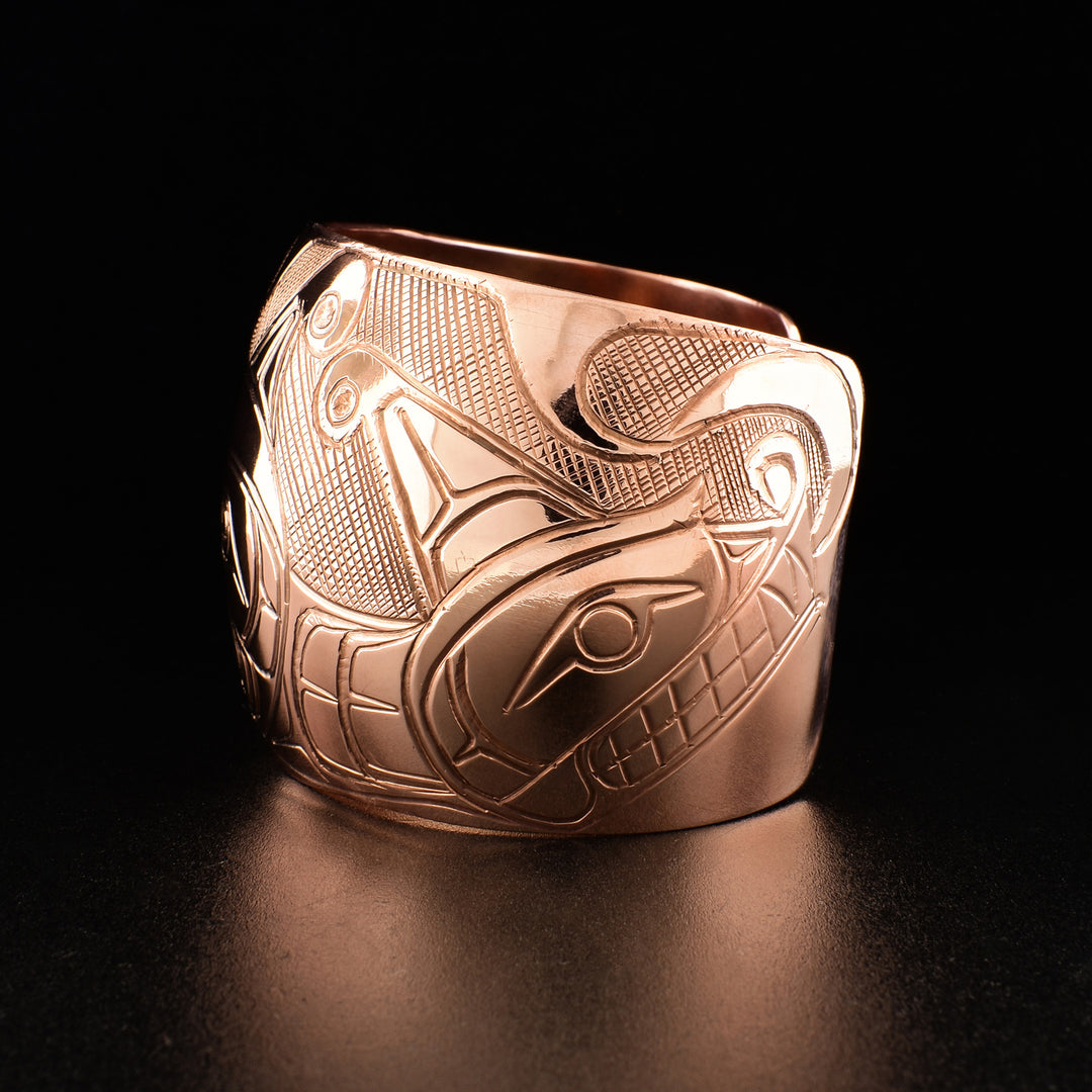 Photo of the left side of the bracelet shows carved design of the other Sisiutl head.