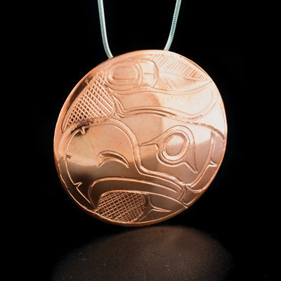 Large round copper thunderbird pendant hand-carved by Kwakwaka'wakw artist Norman Seaweed. Pendant is 2" in diameter. Hidden bail on back. Chain not included.