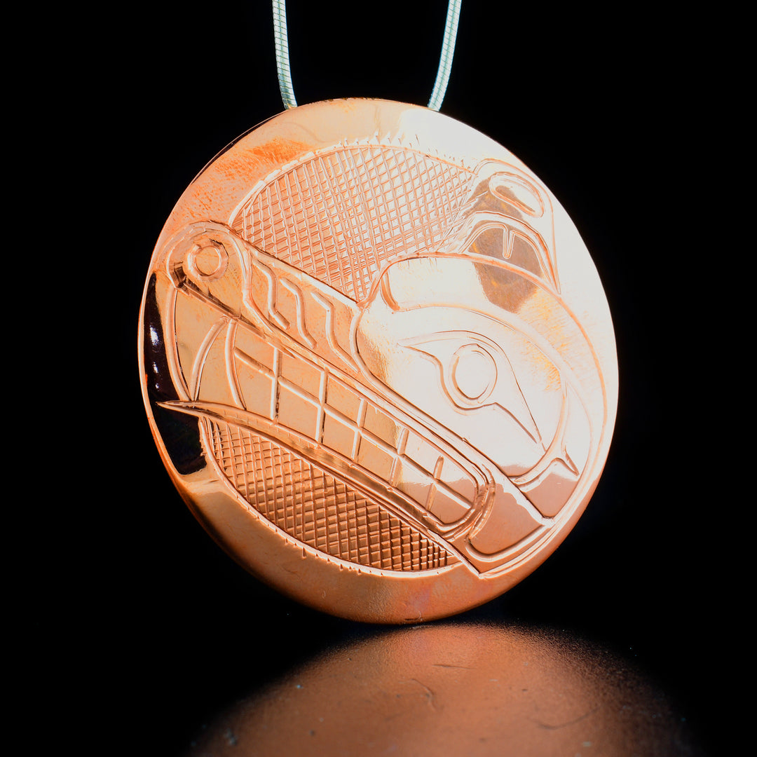 Large round copper wolf pendant hand-carved by Kwakwaka'wakw artist Norman Seaweed. Pendant is 2" in diameter. Hidden bail on back. Chain not included.