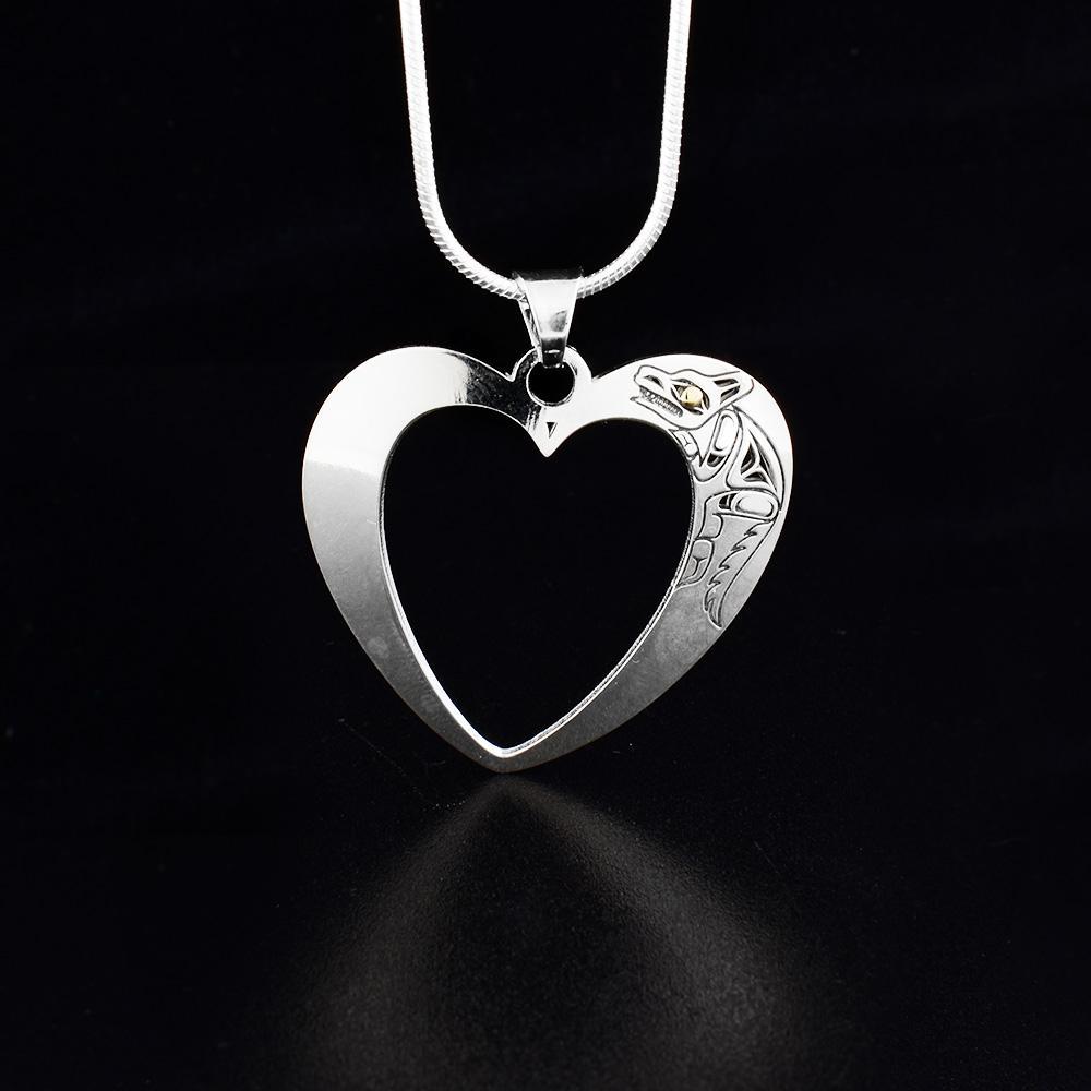 This heart pendant is made from sterling silver and has a depiction of the Wolf cast into the corner of the pendant. The pendant is heart shaped and has a large heart shaped cutout in the center of it.