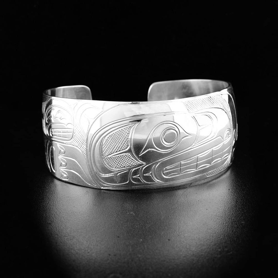 A sterling silver cuff Bear bracelet that is 1" in width, and has the face and body of the Bear handcarved on it.