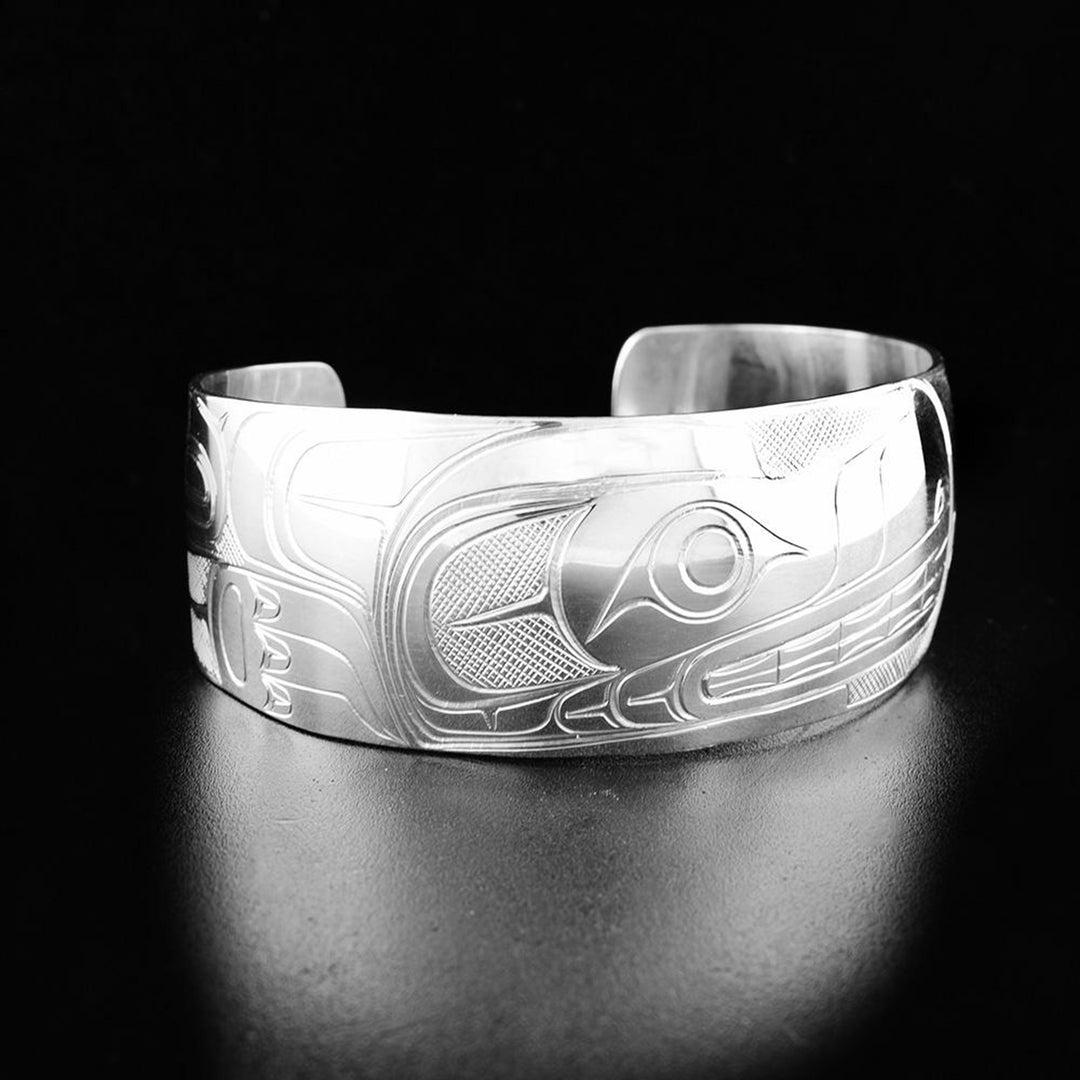 This Wolf bracelet cuff has a wide, slightly tapered band with a gap in the back. There are gorgeous carvings on the surface of the piece depicting the Wolf.