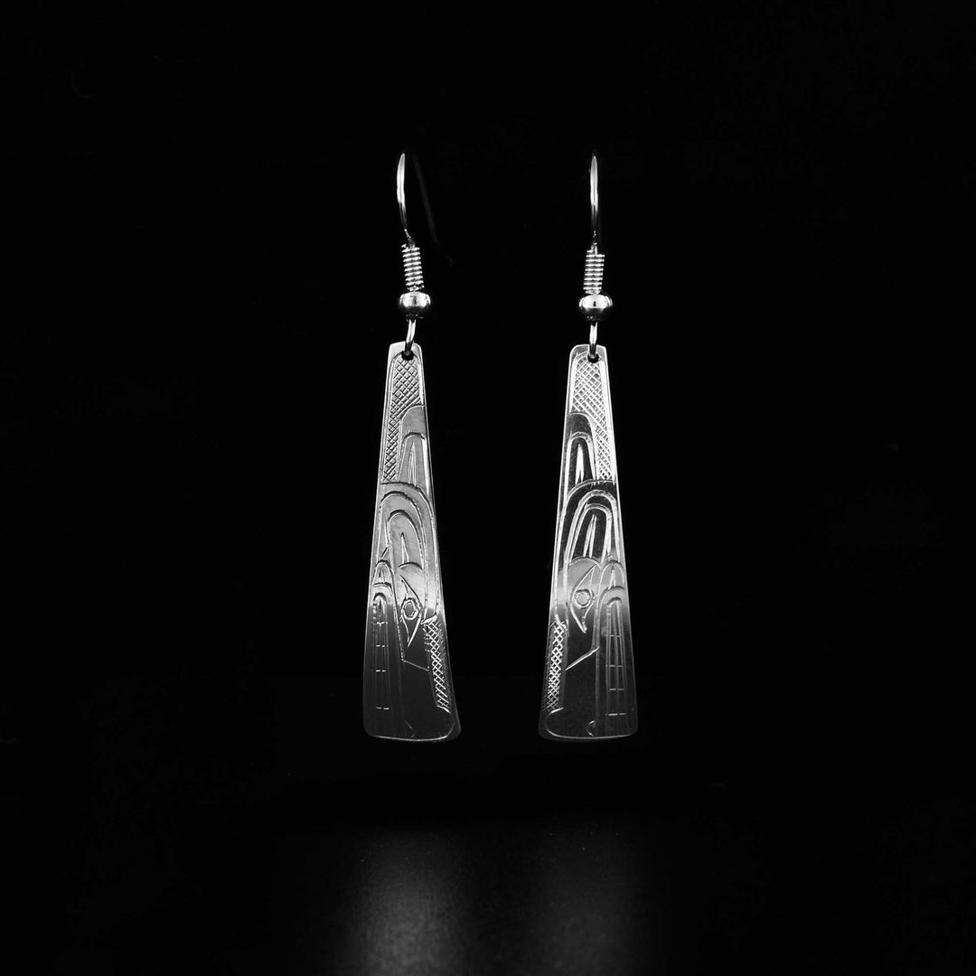 These dangling Wolf earrings have long, vertical, tapered band hangs. There are carvings on the surface of the hangs depicting the Wolf.