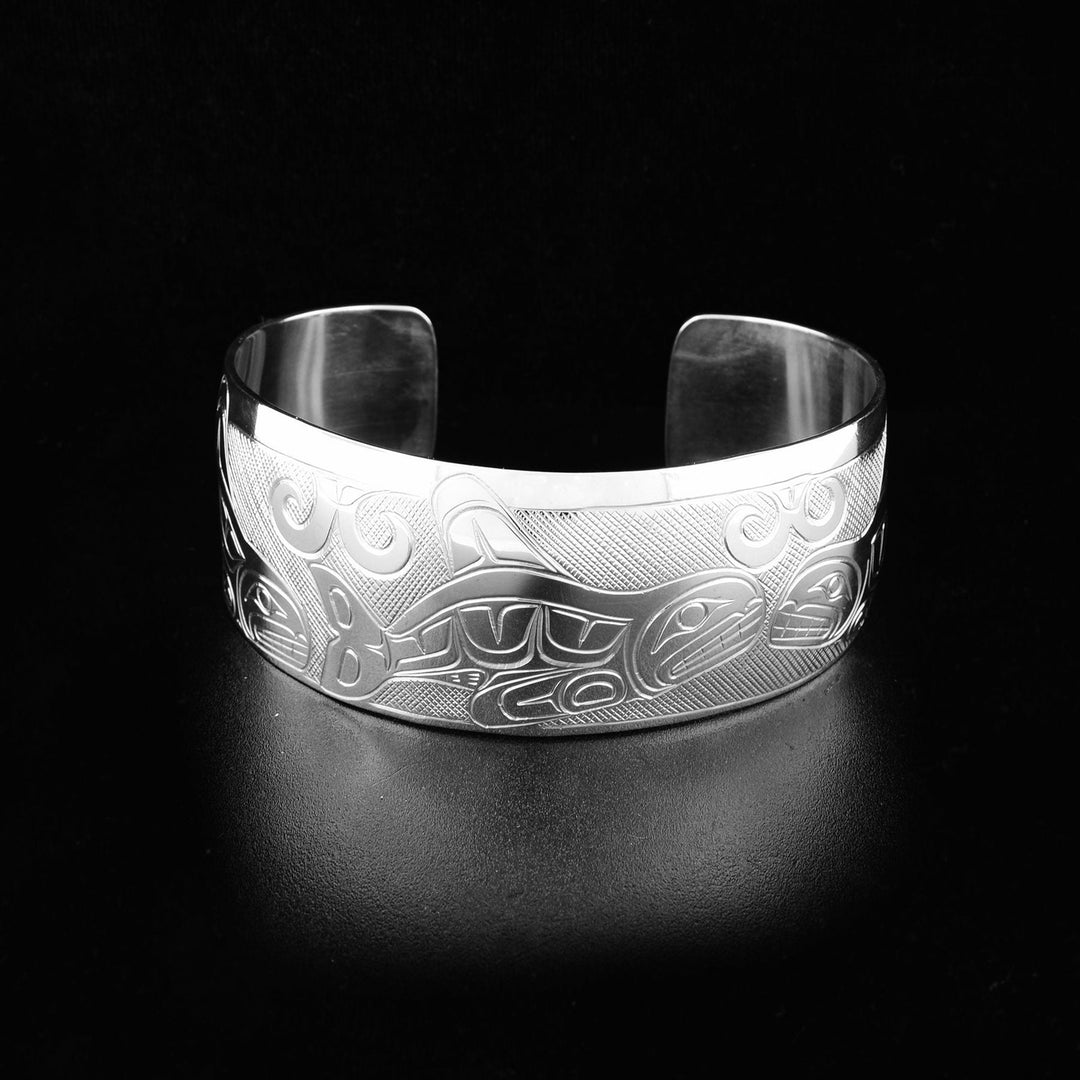 This sterling silver cuff bracelet that depicts the face and body of the Orca. It is handcarved on a long piece of sterling silver.