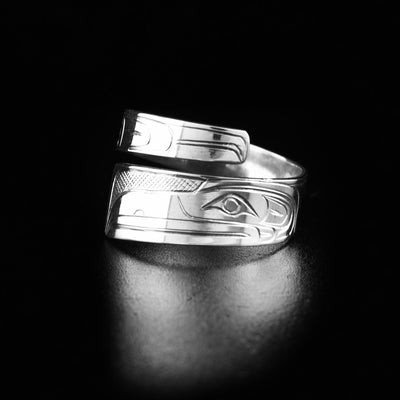 This wrap ring has the profile of a raven's head on the lower half facing the left. There are carved designs representing the feathers of the raven along the ring.