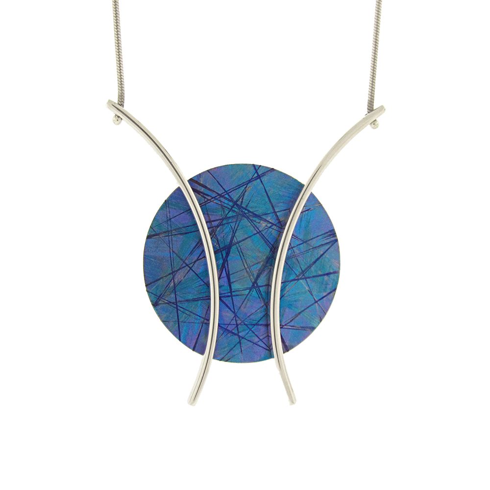 This titanium necklace is made from sterling silver and anodized titanium and has a circle shaped pendant. The circle part of the pnedant is blue and made of titanium, the color and signs on the titanium has been achieved by anodizing it. There are silver wires curved out from the pendant.